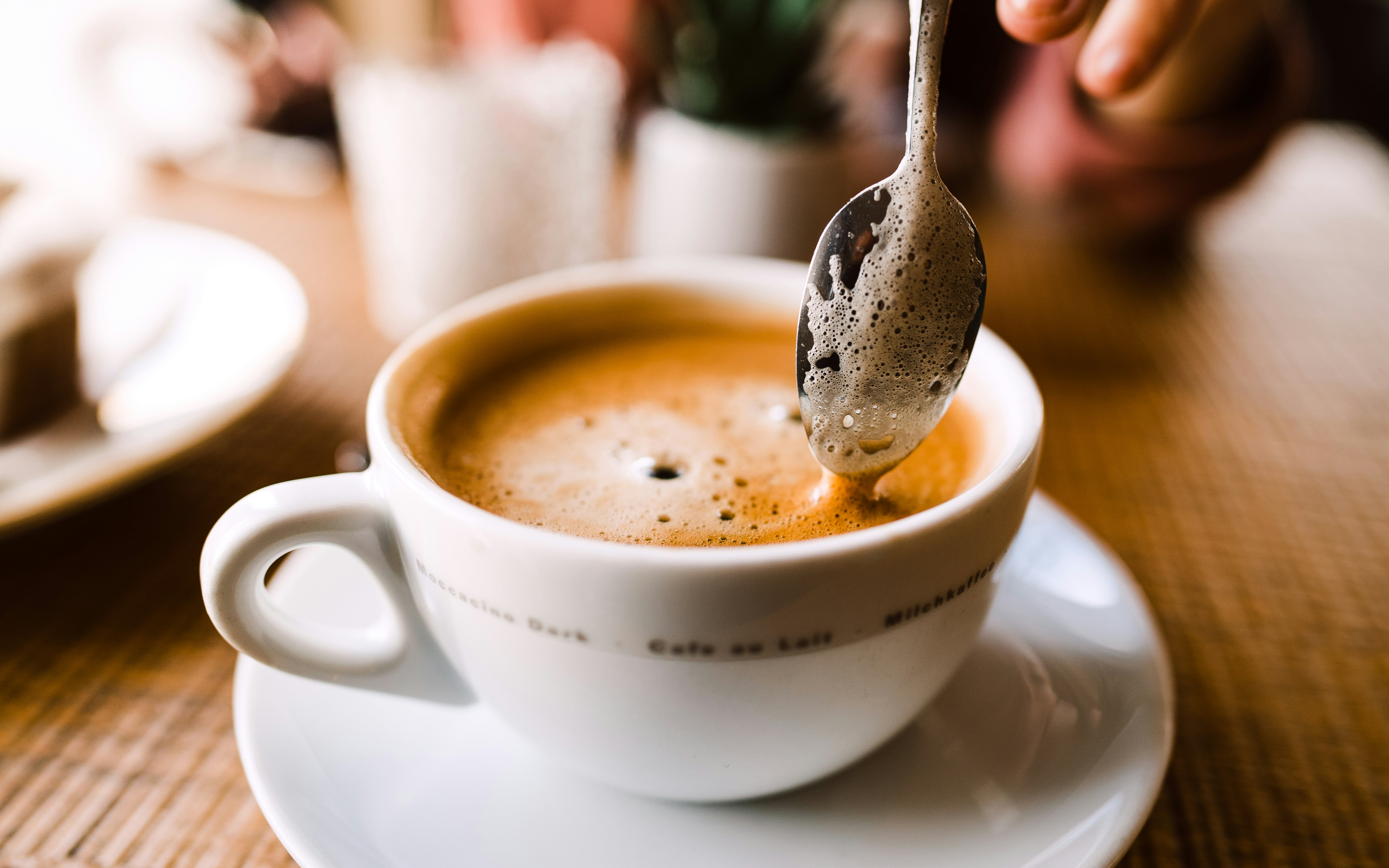 white ceramic cup with stainless steel spoon